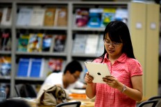 A student in Beijing uses her iPad to search for information.