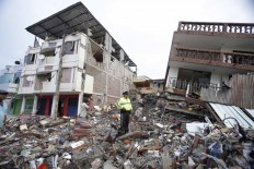 Rubble from a collapsed building lays on the ground in Tarqui, the business district of Manta, Ecuador, Sunday, April 17, 2016. A powerful, 7.8-magnitude earthquake shook Ecuador's central coast on Saturday, killing hundreds. AP Photo/Dolores Ochoa