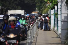 Alfini began to block a group of motorcycle attempting to avoid traffic by trespassing on a sidewalk on Monday. She took action to protest unruly bikers. The Jakarta Post/ Dhoni Setiawan