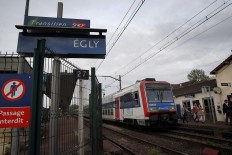 Passengers get off a train at the Egly station, south of Paris, Wednesday, May 11, 2016. French authorities opened an investigation Wednesday after a teenage woman allegedly live-streamed video of her suicide on the popular app Periscope. The local prosecutor said the young woman threw herself under a commuter train in the suburban Egly station, south of Paris. 