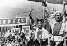 FILE - In this file photo taken Aug. 29, 1966, drummers raise their cymbals and sticks as others hold up small booklets containing the writings of then Chairman Mao Zedong during a demonstration by Red Guard youth groups in front of the Soviet Embassy in Beijing. AP Photo File
