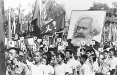 FILE - In this file photo taken Sept. 14, 1966, youths are seen at a rally during the height of the Red Guard upheaval waving copies of the collected writings of Communist Party Chairman Mao Zedong, often referred to as Mao’s Little Red Book and carrying a poster of Karl Marx. AP Photo File
