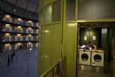 In this Monday, April 25, 2016 photo, In this Sunday, May 1, 2016 photo, Afghan refugee Siratullah Hayatullah, 23, washes in a washing room in the former prison of De Koepel in Haarlem, Netherlands.  The Dutch government has let Belgium and Norway put prisoners in its empty cells and now, amid the huge flow of migrants into Europe, several Dutch prisons have been temporarily pressed into service as asylum seeker centers. AP Photo/Muhammed Muheisen
