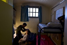 In this Sunday, May 1, 2016 photo, Yazidi refugee Yassir Hajji, 24, from Sinjar, Iraq, adjusts the eyebrow of his wife Gerbia,18, at their room in the former prison of De Koepel in Haarlem, Netherlands.  AP Photo/Muhammed Muheisen