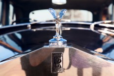 A Rolls-Royce hood ornament and emblem.