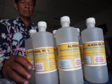 Sabaryono arranges bottles of alcohol ready for distribution. JP/ Ganug Nugroho Adi
