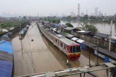A Commuter Line train is forced to stop 500 meters before Tanah Abang Station due to a flood on January 17, 2013. JP/Ricky Yudhistira