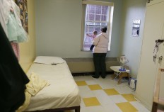 In this April 12, 2016 photo, Jennifer Dumas looks out the window with her daughter, Codylynn, inside her room at Bedford Hills Correctional Facility, in Bedford Hills, N.Y. Bedford Hills has one of only eight working prison nurseries where women live with their babies, out of more than 100 women's prisons around the country. 