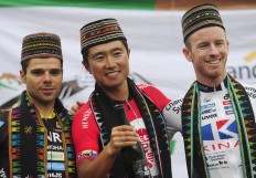 Fourth-stage winners Liu Jianpeng (center), Benjamin Prades (left) and Jai Crawford pose for pictures after receiving traditional scarves and caps as a local version of winning jerseys. ANTARA FOTO/Wahyu Putro A