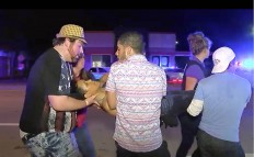 An injured person is escorted out of the Pulse nightclub after a shooting rampage, Sunday morning June 12, 2016, in Orlando, Fla. A gunman wielding an assault-type rifle and a handgun opened fire inside a crowded gay nightclub early Sunday, killing at least 50 people before dying in a gunfight with SWAT officers, police said. It was the deadliest mass shooting in American history. AP Photo/Steven Fernandez
