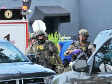 FBI, Orlando Police Department and the Orange County Sheriff's Office personnel investigate the attack at the Pulse nightclub  in Orlando Fla., Sunday, June 12, 2016. A gunman wielding an assault-type rifle and a handgun opened fire inside a crowded gay nightclub in Orlando, Fla.,early Sunday, before dying in a gunfight with SWAT officers, police said. It was the worst mass shooting in American history.  Craig Rubadoux/Florida Today via AP