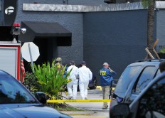 FBI, Orlando Police Department and the Orange County Sheriff's Office personnel investigate the attack at the Pulse nightclub in Orlando Fla., Sunday, June 12, 2016. A gunman wielding an assault-type rifle and a handgun opened fire inside a crowded gay nightclub in Orlando, Fla.,early Sunday, before dying in a gunfight with SWAT officers, police said. It was the worst mass shooting in American history.  Craig Rubadoux/Florida Today via AP