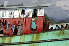 Women and children are seen on the boat. The vessel is carrying 20 men, 15 women and nine children.The Jakarta Post/ Hotli Simanjuntak