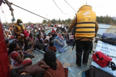 Indonesian authorities collect information on the asylum seekers on board the vessel. The Jakarta Post/Hotli Simanjuntak