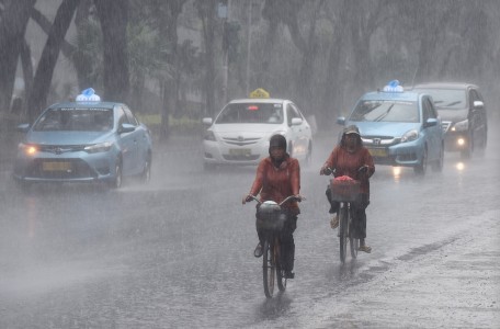 Two people riding bicycles through the rain in Jl. Merdeka Selatan of Central Jakarta on June 9. The Meteorology, Climatology and Geophysics Agency (BMKG) predicts La Nina phenomenon marked with high intensity rain will hit Indonesia in July to September.