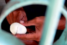 Half a hard-boiled egg is added to each bowl of bubur India. People believe that the porridge provides energy while fasting. JP/ Albertus Magnus Kus Hendratmo