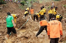 13 killed as landslides bury Central Java villages