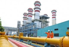 Two technicians monitor gas pipes at a facility operated by state-owned gas firm PGN.