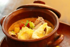 'Soto Betawi' usually consists of rich broth made from coconut milk and beef, fried potatoes and tomato.
