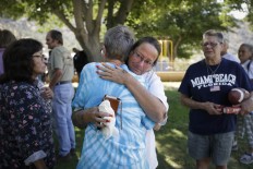 Evacuee Rene Czajka, facing camera, gets emotional as she comforts Cathy Berlin who lost her home in a wildfire as they gather for a briefing at an evacuation center, Saturday, June 25, 2016, in Kernville, Calif. AP Photo/Jae C. Hong