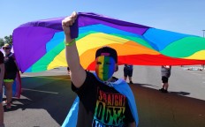 Hunter Kusak, of Syracuse, N.Y., holds up the rainbow flag during the Gay Pride Parade in Syracuse on Saturday, June 18, 2016. Thousands of people have attended a lesbian, gay, bisexual and transgender pride parade and festival in upstate New York, less than a week after a deadly attack at a gay nightclub in Orlando, Fla. Michael Greenlar/The Syracuse Newspapers via AP