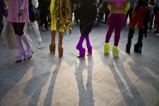 Transvestites wearing platform shoes pose for photos during the 16th annual gay pride parade to mark the upcoming International Gay Pride Day, and to honor the victims of the Orlando nightclub shooting, in Santiago, Chile, Saturday, June 25, 2016. Marchers are also demanding laws in favor of same sex marriage and gender identity. AP Photo/Esteban Felix