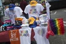Gay pride merchandise is on display on a street vendor's table in the Greenwich Village neighborhood of Manhattan, Saturday, June 25, 2016 in New York. AP Photo/Mary Altaffer