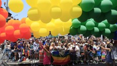 Balloons pass by people watching the NYC Pride Parade in New York, Sunday, June 26, 2016.  Sunday's parades in New York, San Francisco and other cities are unfolding two weeks after a gay nightclub in Florida became the site of the nation's deadliest mass shooting by a single gunman in modern U.S. history. The parade is a celebration of barriers breached and a remembrance of the lives lost in the massacre at a gay nightclub in Orlando. AP Photo/Seth Wenig