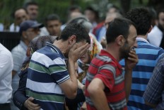 Family members of victims cry outside the Forensic Medical Center in Istanbul, Wednesday, June 29, 2016. AP Photo/Emrah Gurel