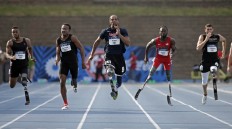 In this July 1, 2016 photo, runners, from left, Michael Asefa, Desmond Jackson, Shaquille Vance, Regas Woods and Trevor Wallace compete in a men's 100-meter dash final race during the U.S. Paralympics Team Trials in Charlotte, N.C. AP Photo/Chuck Burton
