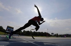 In this Friday, July 1, 2016 photo, Kionte Storey practices his starts before his heat in the men's 100-meter dash during the U.S. Paralympics Team Trials in Charlotte, N.C. AP Photo/Chuck Burton