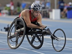 In this Friday, July 1, 2016 photo, Brian Seimann races during a men's 100-meter dash final during the U.S. Paralympics Team Trials in Charlotte, N.C. AP Photo/Chuck Burton