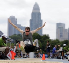In this Friday, July 1, 2016 photo, Eric Johnson competes in the men's long jump during the U.S. Paralympics Team Trials in Charlotte, N.C. AP Photo/Chuck Burton
