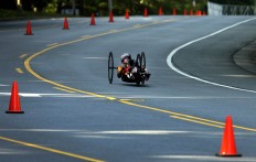 In this Saturday, July 2, 2016 photo, Alicia Dana pedals around a curve during the cycling time trials in the U.S. Paralympics Team Trials in Charlotte, N.C. AP Photo/Chuck Burton