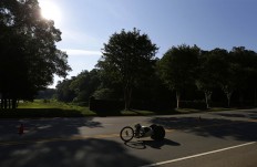 In this Saturday, July 2, 2016 photo, Oksana Masters pedals down the course during the cycling time trials in the U.S. Paralympics Team Trials in Charlotte, N.C. AP Photo/Chuck Burton
