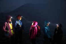 Five female trekkers take a rest after arriving at the peak of Mount Ijen in East Java on May 5. They climbed to the peak to observe the rare Blue Fire phenomenon. JP/P J Leo