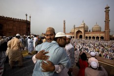 Indian Muslims hug and greet each other after offering Eid al-Fitr prayers at the Jama Mosque in New Delhi, India, Thursday, July 7, 2016. Eid al-Fitr marks the end of the Muslim holy fasting month of Ramadan.AP Photo/Manish Swarup
