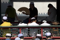 Muslim residents attend Eid al-Fitr prayers at the Niujie mosque, the oldest and largest mosque in Beijing, Wednesday, July 6, 2016. The Eid al-Fitr celebrations mark the end of the Muslim holy fasting month of Ramadan. AP Photo/Ng Han Guan