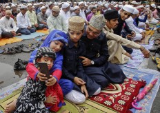 An Indian Muslim family takes a selfie after offering Eid al-Fitr prayers in Mumbai, India, Thursday, July 7, 2016. Eid al-Fitr marks the end of the Muslim holy fasting month of Ramadan. AP Photo/ Rajanish Kakade 
