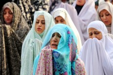 Iranian women attend Eid al-Fitr prayers in Tehran, Iran, Wednesday, July 6, 2016. Eid al-Fitr marks the end of the muslim fasting month of Ramadan. AP Photo/Ebrahim Noroozi