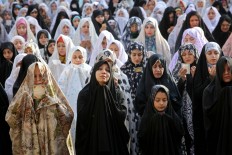Iranian women pray during the Eid al-Fitr prayers in Tehran, Iran, Wednesday, July 6, 2016. Eid al-Fitr marks the end of the Muslim fasting month of Ramadan. AP Photo/Ebrahim Noroozi


