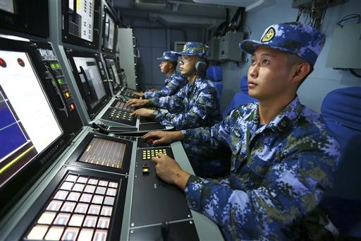 In this Friday, July 8, 2016 photo released by Xinhua News Agency, Chinese navy sailors search for targets onboard the missile destroyer Hefei during a military exercise in the waters near south China's Hainan Island and Paracel Islands. They are controlled by Beijing but also claimed by Vietnam and Taiwan. China's navy is holding a week of military drills around the disputed islands ahead of a ruling by an international tribunal in a case filed by the Philippines challenging China's claim to most of the South China Sea. China is boycotting the case before The Hague-based court and says it will not accept the verdict. 
