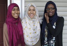 In this July 7, 2016 photo, Kirin Waqar, Lena Ginawi and Hawa Adam, members of Muslim Girls Making Change, pose for a photo in South Burlington, Vt. They are among four teens who will participate in an international youth poetry competition this week in Washington.