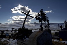 In this July 9, 2016 photo, a cross stands in a snow covered cemetery in San Antonio de Putina in the Puno region of Peru, where people raise alpacas and sheep for their wool. "Every year with the winter freezes and cold temperatures the plants and animals die," said Miguel Hadzich, head of a group affiliated with Peru's Catholic University that on its own has built 600 homes with heating for farmers. "A scandal breaks out and then the state looks the other way. AP Photo/Rodrigo Abd