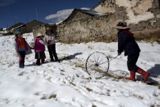 In this July 9, 2016 photo, children play after school in San Antonio de Putina in the Puno region of Peru. Two months into the cold season an estimated 14,000 children in the Andes have suffered from respiratory illnesses and 105 died, according to government figures. AP Photo/Rodrigo Abd