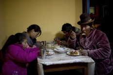 In this July 11, 2016 photo, villagers eat dinner at the town's only general store in San Antonio de Putina in the Puno region of Peru. Peru is the world's largest producer of alpaca wool, and the rural hamlets in this area is where the white-furred alpacas have been raised for centuries. AP Photo/Rodrigo Abd
