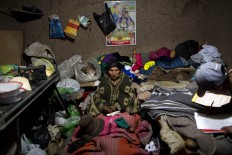 In this July 11, 2016 photo, Vicentina Javier rests inside a relative's adobe home as she recuperates from a respiratory illness in San Antonio de Putina in the Puno region of Peru. Authorities relocated Vicentina, 77, from her home to this village because she was in a even more sparsely populated area where there's no doctor nearby. AP Photo/Rodrigo Abd