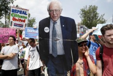Die-hard Sanders' backers divided on backing Clinton 