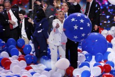 Democratic presidential nominee Hillary Clinton reaches for a falling balloon at the conclusion of the Democratic National Convention in Philadelphia , Thursday, July 28, 2016. AP Photo/J. Scott Applewhite
