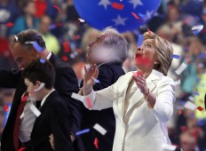 Democratic presidential nominee Hillary Clinton looks up as balloons and confetti fall during the final day of the Democratic National Convention in Philadelphia , Thursday, July 28, 2016. AP Photo/Paul Sancy